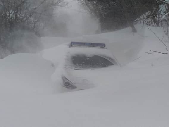 The police vehicle hidden by drifting snow at Catlow Bottoms, Briercliffe