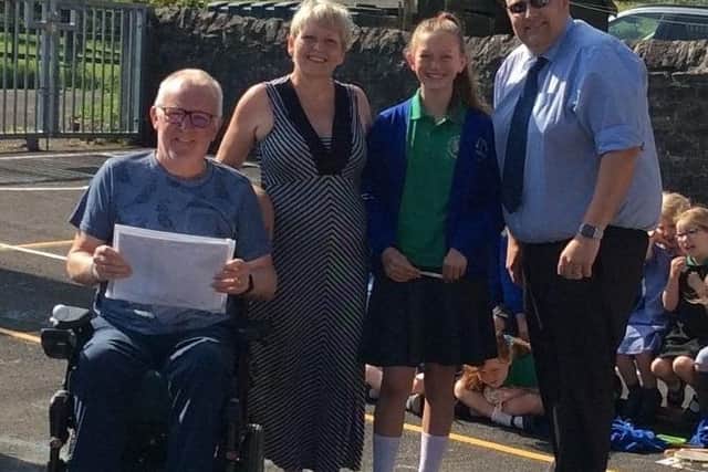 Tony Plant and his wife Janet with Year Six pupil, and close friend of the Plant family, Darcey Madden, and Bolton-by-Bowland Primary School headteacher Paul Holden.