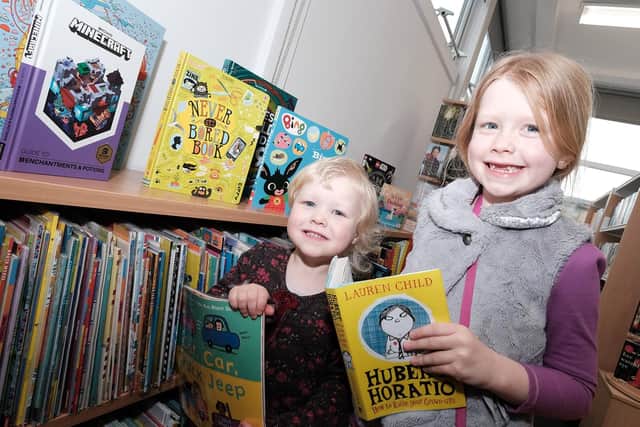 Emily (three) and Lucy Forbes (seven) were among the first visitors to newly re-opened Pike Hill Library.