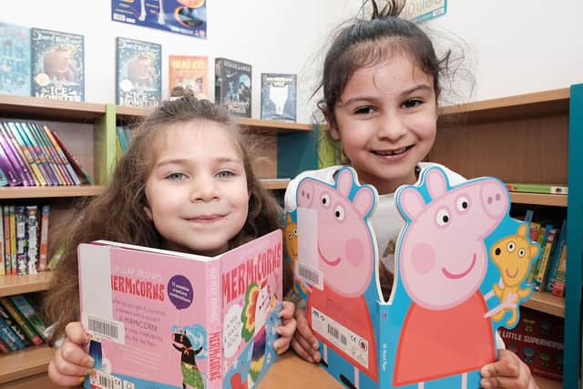 Eidie (five) six-year-old Amirah are pictured choosing their books at Pike Hill Library.