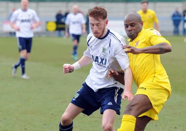 14/3/15  Alex Johnson  of Guiseley  battles for the ball with  Frank Sinclair of  Brackley Town .(GL1005/23h)