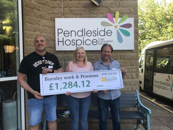 Steve Neary, Melanie Crook and Darren Moss of Burnley Work and Pensions Department with a cheque for the cash they raised for Pendleside Hospice in 2017.
