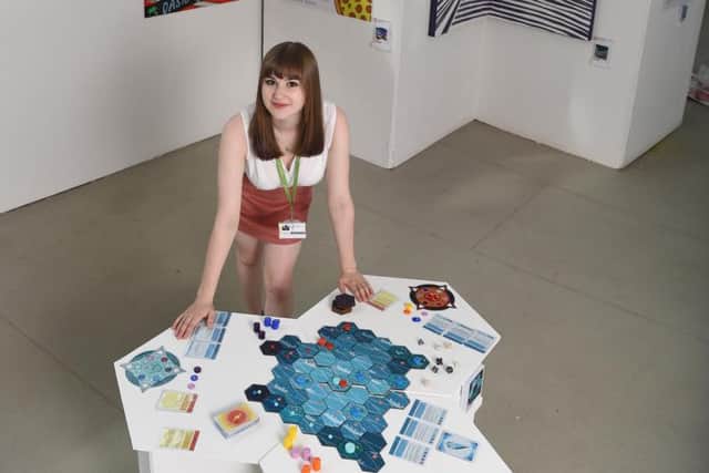 Caitlin Stracey with her board game design. (s)