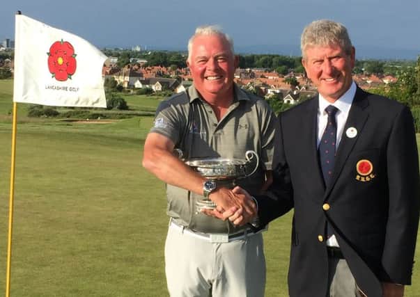 New Lancashire county seniors golf champion Tony Flanagan from Clitheroe Golf Club, receives the trophy from Mike Lay, Lancashire Union of Golf Clubs President