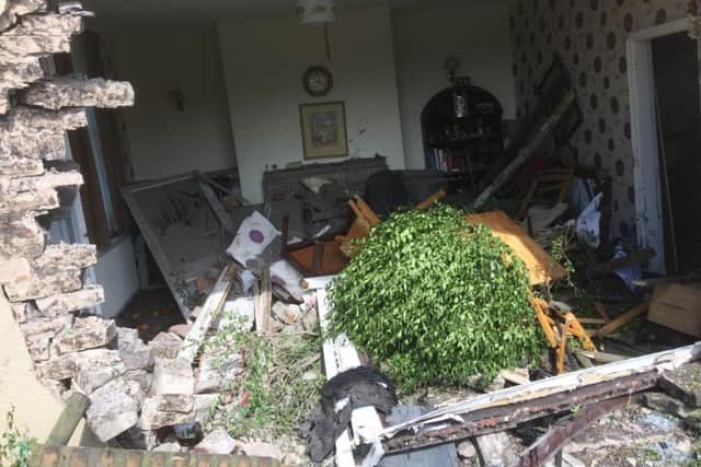 The wreckage in the living room at the house in Accrington Road, Burnley, after a car crashed into it.