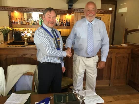 Alan Clifford hands the chain of office to incoming president of Clitheroe Lions Club John Wilkinson.