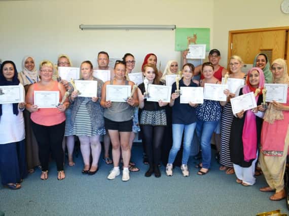 The award winning parents proudly show off their certificates after completing the course.