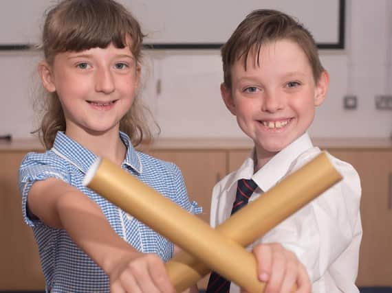 Year five pupils Archie Kay and Olivia Longley with their university scrolls.