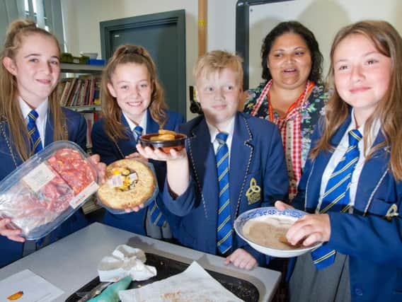 Students Maddi Shepherd, Isabel Burns, Leo Redman and Ruby Brittain  prepare to learn Spanish cooking with teacher Miriam Janigova from the Faith Centre
