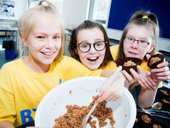 Jemima Redmond, Liv Daley and Josie Bennett make Rice Krispie cakes at the Blessed Trinity RC College summer school.