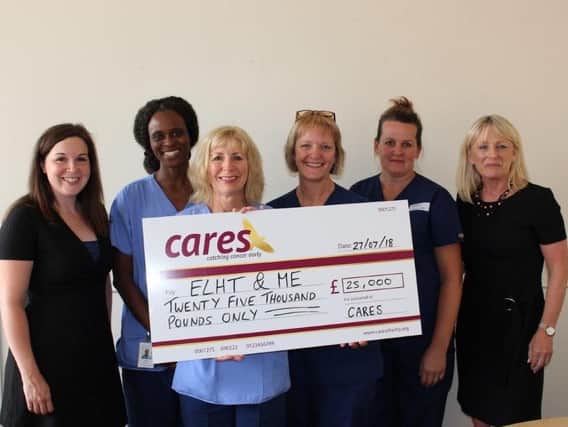 Fundraising Manager for CARES and Sharon Froggatt, Relationship Manager for CARES, present the 25k cheque to Endoscopy Unit staff.