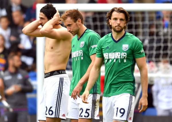 West Bromwich Albion's Craig Dawson (centre) after the final whistle with team-mates Jay Rodriguez (right) and Ahmed Hegazi during the Premier League match at Selhurst Park, London. PRESS ASSOCIATION Photo. Picture date: Sunday May 13, 2018. See PA story SOCCER Palace. Photo credit should read: Dominic Lipinski/PA Wire. RESTRICTIONS: EDITORIAL USE ONLY No use with unauthorised audio, video, data, fixture lists, club/league logos or "live" services. Online in-match use limited to 75 images, no video emulation. No use in betting, games or single club/league/player publications.