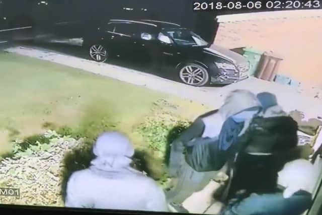 This chilling still image of the masked men shows them outside the window of the family home in Worsthorne.