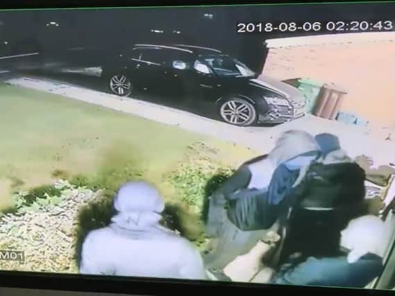 This chilling still image of the masked men shows them outside the window of the family home in Worsthorne.