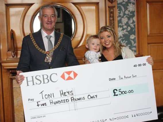 Mayor of Burnley Coun. Charles Briggs presents Toni Heys with a cheque for 500