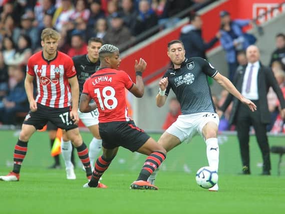 Stephen Ward challenges Mario Lamina for the ball