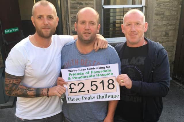 (From left) Danny, Scott, and John with the cheque awarded to their two chosen charities.
