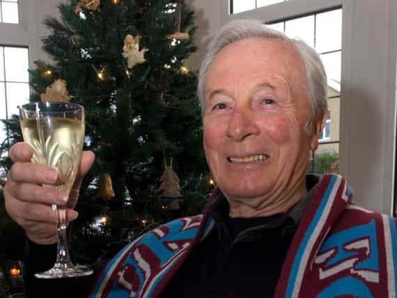 Jimmy McIlroy toasting his MBE in December, 2010