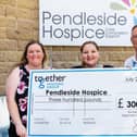 Heather Conn and Sammi Graham from Pendleside Hospice with Together Housing Groups director of strategy and communication Ian Clark. (s)