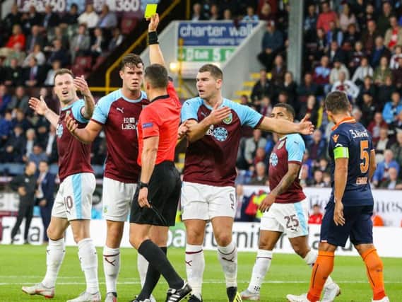 Burnley's Kevin Long reacts after being shown the yellow card by referee Istvan Kovacs