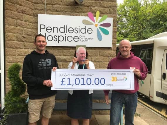 The intrepid climbers handing the cheque to Pendleside Hospice.