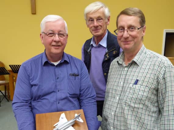 Ian Ferguson (left) receiving the model from Alan Pickles (centre) and David Holmes