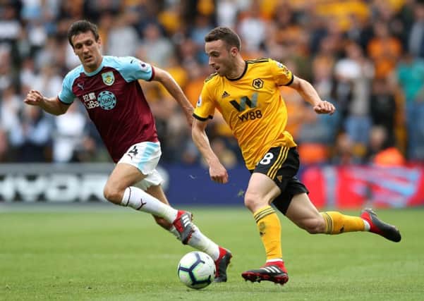Burnley's Jack Cork (left) and Wolverhampton Wanderers' Joao Moutinho battle for the ball during the Premier League match at Molineux, Wolverhampton. PRESS ASSOCIATION Photo. Picture date: Sunday September 16, 2018. See PA story SOCCER Wolves. Photo credit should read: Nick Potts/PA Wire. RESTRICTIONS: EDITORIAL USE ONLY No use with unauthorised audio, video, data, fixture lists, club/league logos or "live" services. Online in-match use limited to 120 images, no video emulation. No use in betting, games or single club/league/player publications.