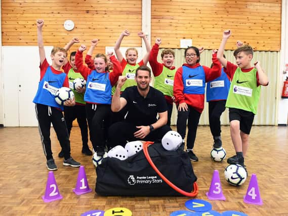 Tom Heaton with pupils at Whittlefield Primary School