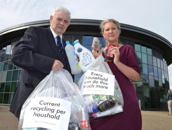 County Coun. Albert Atkinson, deputy leader, and Janine Lund, waste management officer, showing how much more the average household could recycle each week.