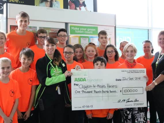 Asda community colleagueAnnette McGowan-Doe and People Trading Manager  Jane Broadfootpresent the cheque to Clayton Harriers' juniors co-ordinator Marion Wilkinson and some of the club juniors.