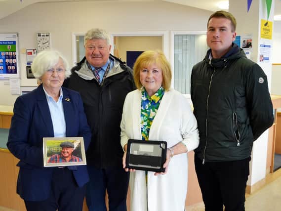 Dougie Macadam, Patrick Macadam, Catriona Lloyd-Davies (nee Macadam) and Mary Macadam present the donated iPads to East Lancashire Hospitals Cancer Services staff
