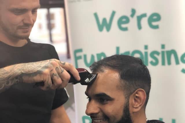 Barber Attiq during his sponsored headshave for Pendleside Hospice