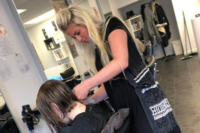 No turning back for Millie as stylist Jodie Derbyshire gets to work on her new short crop at Padiham's Vanilla hair salon.
