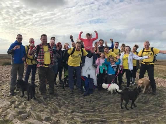 Businesswise Solutionss staff, family and friends celebrating reaching the final peak of their Pendle Three Peaks Challenge.