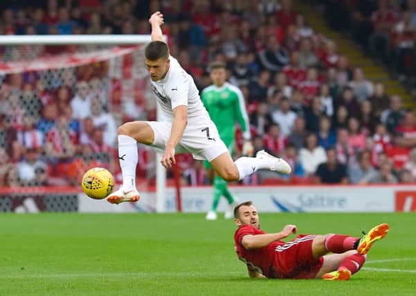 Burnley's Johann Berg Gudmundsson (left) jumps over Aberdeen's Niall McGinn during the UEFA Europa League second qualifying round, first leg match at Pittodrie Stadium, Aberdeen. PRESS ASSOCIATION Photo. Picture date: Thursday July 26, 2018. See PA story SOCCER Aberdeen. Photo credit should read: Ian Rutherford/PA Wire