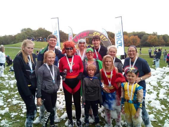 Isaac (front) with his family after taking part in the Kapow Superhero Challenge event to raise money for research into juvenile diabetes.