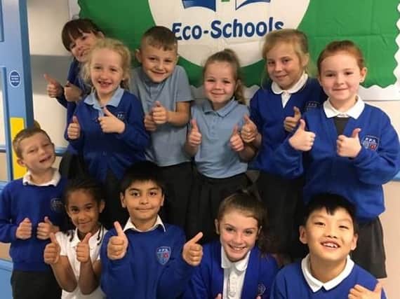 Children from Padiham Primary School give the thumbs up after being awarded the Eco Schools Green Flag.
