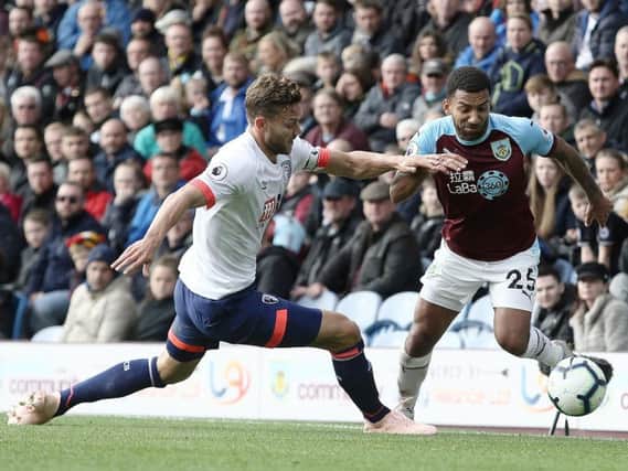 Burnley's Aaron Lennon holds off the challenge from Bournemouth's Simon Francis