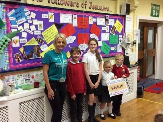 Jo Applegate with children at the school