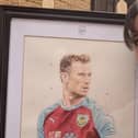 Louise Cobbold with her painting of Ashley Barnes.