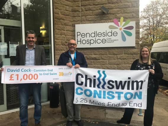 David Cock and Tony Livesey present the amount to Pendleside Hospice.