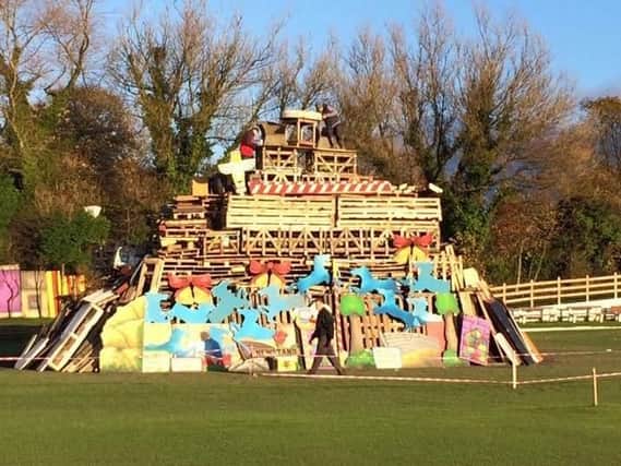 Organisers are pictured putting the finishing touches to last year's bonfire at Lowerhouse Cricket Club and this year's promises to be even bigger and better.
