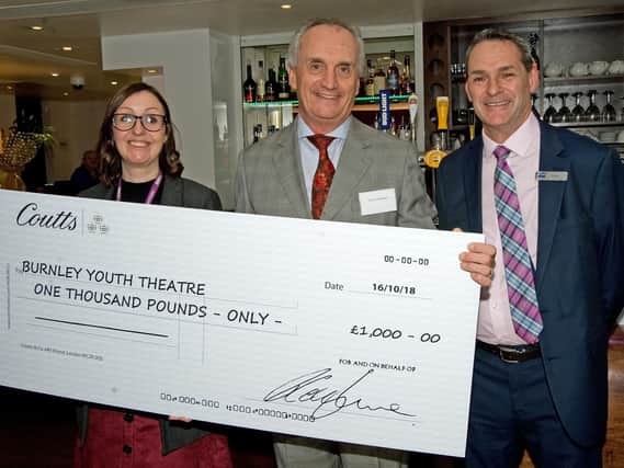 Paul Callingham and Steve Walmsley of Starboard Hotels, hand over the cheque for 1,000 to Karen Metcalfe from Burnley Youth Theatre for its Raise the Roof Fund.