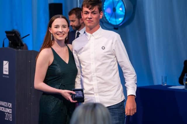 Aidan Ferns is presented with his award by Chloe Wilkinson