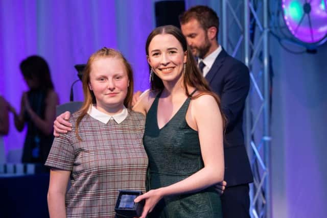 Prize winning Emily McLoughlin receives her award from Chloe Wilkinson.