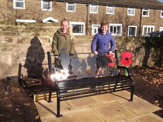 Worsthorne Primary School students Freya Fenwick and Louis Woodruff pictured next to the memorial bench in the village.