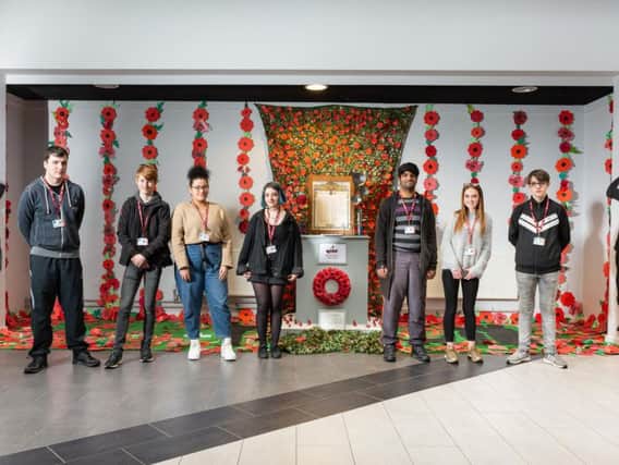 Burnley College students in front of the Remembrance memorial they created.