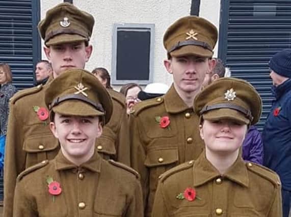 Emily (front right) with other young people who donned World War One soldiers' uniforms for Remembrance Sunday.