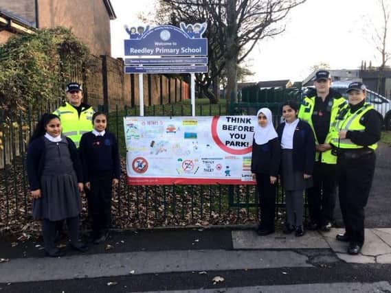 (From left) PC Steve Murphy, PCSC Dan Richards, and PSCO Trish Ashworth with pupils from Reedley Primary School in Brierfield.