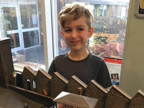 Archie Cannon-Armstrong (eight) at the controls of a model of Oswaldtwistle Town.